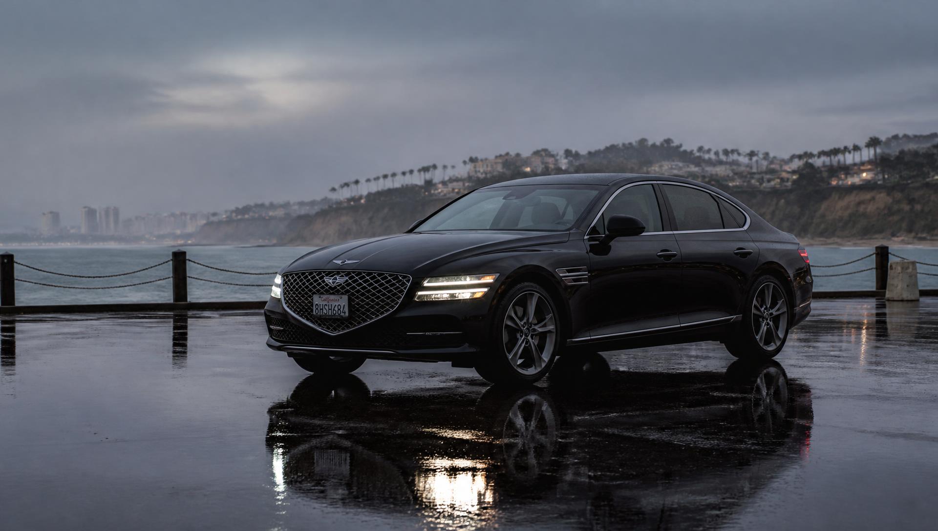 Mirror-wet black luxury car at dusk in San Pedro, freshly detailed by AutoGlow